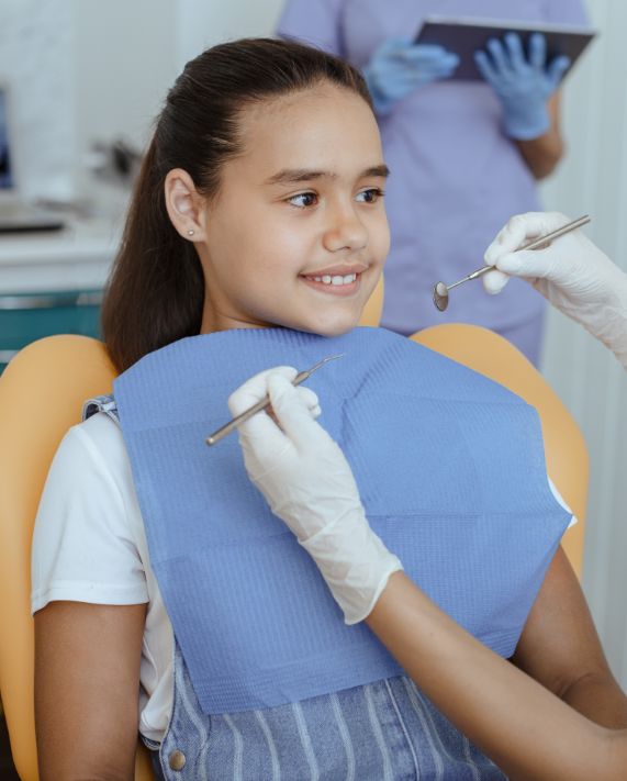 young girl receiving a dental exam in Tucson, AZ
